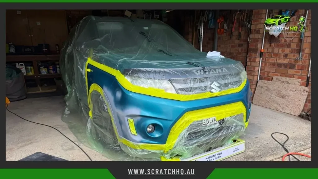 Suzuki Vitara masked with tape and plastic in garage for car scratch repair