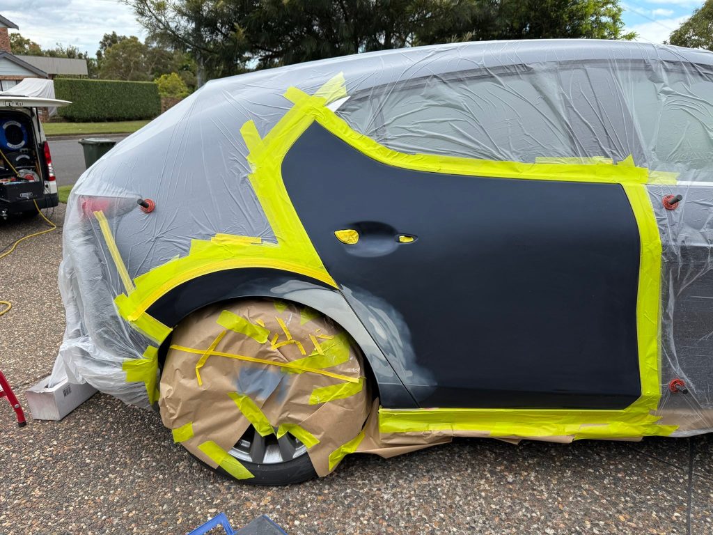 Car panel masked and prepared for scratch repair and repainting in Sydney