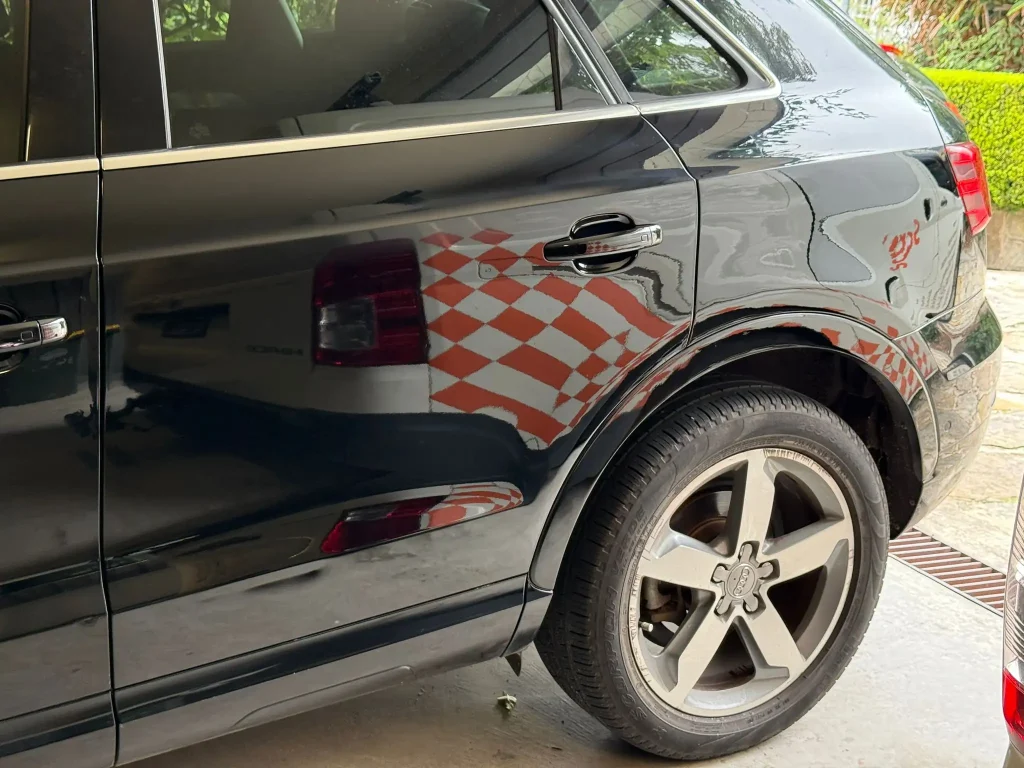 Black Audi SUV after professional car scratch repair with restored paint finish and no visible damage in Sydney