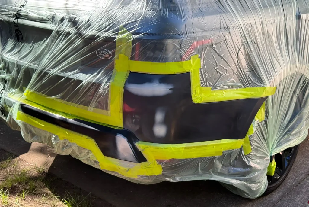 Land Rover rear bumper masked and prepared for professional scratch repair and repainting in Sydney.