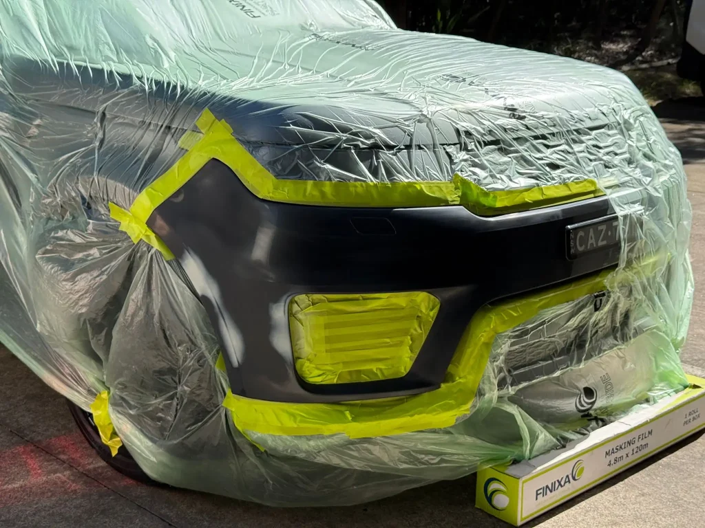 Vehicle rear bumper prepared for paint correction and scratch repair service in Sydney.